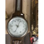 A oak barometer and a reproduction gilt mantel clo