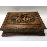 A carved wooden black forest Jewellery box 33 x 24