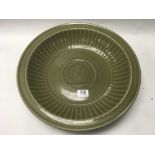 A large Chinese celadon glazed ribbed bowl with ce