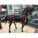 A vintage large leather horse, approx height 65cm.