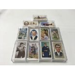 A collection of 11 sets of cigarette cards includi