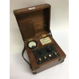 A vintage cased brass bound mahogany electric OHMS