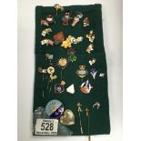 A collection of various pin badges including Golde