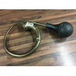 A vintage brass car horn.