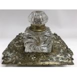 A large glass Victorian inkwell on brass base