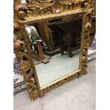 A pair of gilt framed mirrors with floral shell de