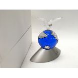 A Swarovski crystal Planet 2000, boxed with stand.