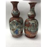 Two Japanese bottle vases decorated with figures f