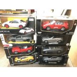 A collection of cars, including Porsche Mercedes ect. All boxed.