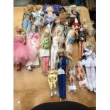 A box containing a collection of loose dolls inclu