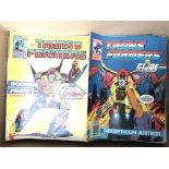 A box containing a collection of Transformers comi