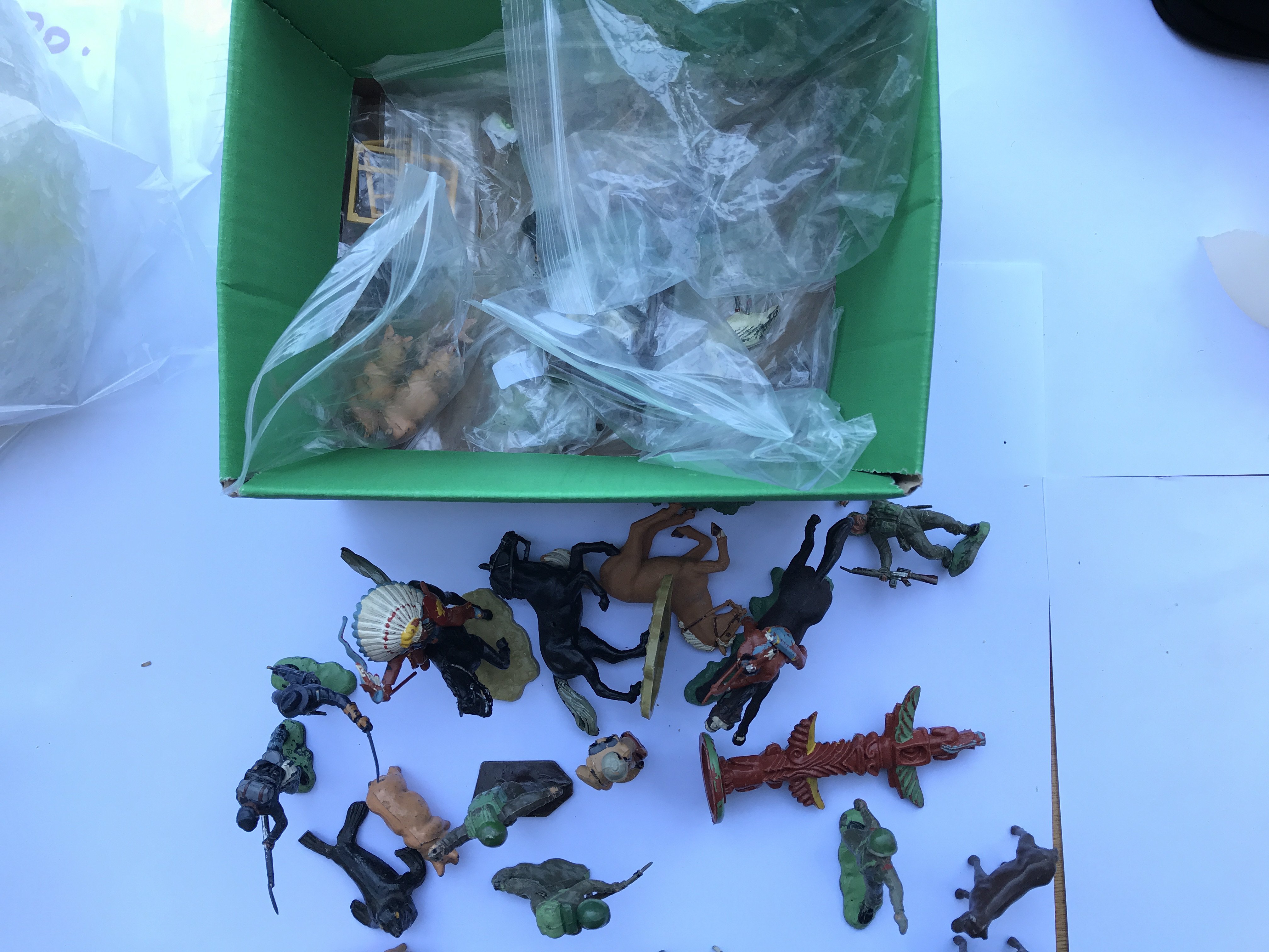 A box with a collection of Britain's,lone Star and other figures.
