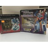 A boxed Transformers jump starter and a boxed Tran