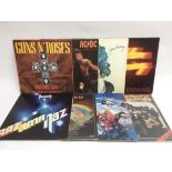 Seven rock LPs by various artists including AC/DC,