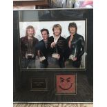 A framed and glazed signed Bon Jovi photo display with COA, approx 54cm x 59cm.