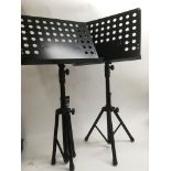 Two sheet music stands and a box of leads includin