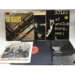 A collection of Beatles LPs and singles.