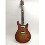 A PRS SE electric guitar fitted with twin humbucke