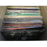 A box of LPs and 12 inch singles by various artist