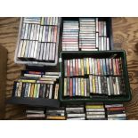 A collection of cassettes by various artists inclu