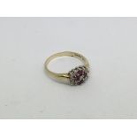 A 9ct gold ring set with 4 Ruby's and diamond clus