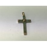 A 9ct gold and jade cross.