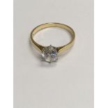 A 14 ct gold ring inset with A single C Z stone .