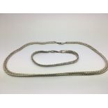 A silver necklace and matching bracelet (2).