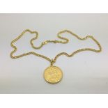 A 1912 gold sovereign on a yellow metal chain, tot