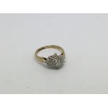 A 9ct gold ring set with a 23 diamond cluster appr