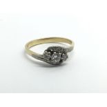 An 18ct yellow gold and three stone diamond ring,