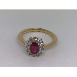 An 18ct yellow gold oval -cut ruby and RBC diamond