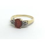 An 18ct yellow gold ring set with fire opal and si