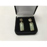 A pair of 9ct gold earrings set with jade.