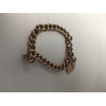 A 9 ct gold bracelet with heart attached clasp 13