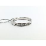 An 18ct white gold half eternity ring set with a b