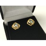 A pair of 18ct gold screwbacked aquamarine set stu