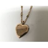 A gold necklace with a heart shaped locket set wit