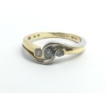 An 18ct gold and three stone diamond ring, approx