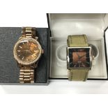 A rose gold Michael Kors watch together with a Ben