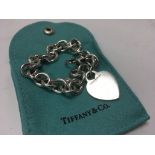 A Tiffany and Co. silver heart bracelet.