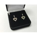 A pair of 9ct white gold and diamond heart drop ea