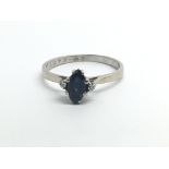 An 18ct white gold ring with central sapphire and