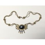 An unusual silver necklace inset with black stones