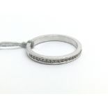 An 18ct white gold and diamond half eternity ring,