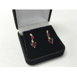 A pair of 9ct gold ruby and diamond earrings.