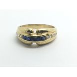 An 18ct yellow gold ring set with a row of sapphir