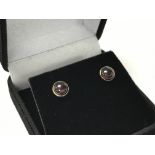 A pair of 14ct gold studs set with cabochon garnet