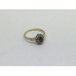 A 9ct gold ring set with a sapphire and diamond cl