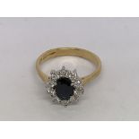 An 18ct yellow and white gold oval-cut sapphire an